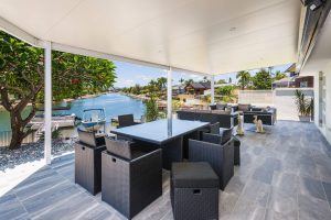 Covered patio with river view and modern furniture